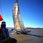 Picture of a sailboat from the deck of another